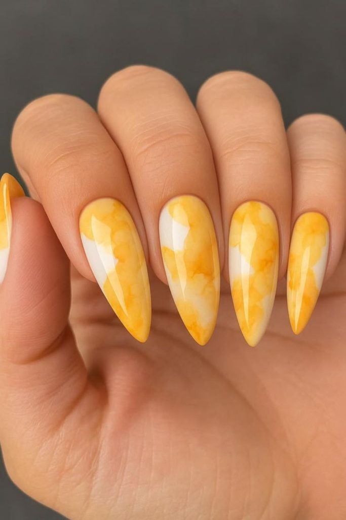 Marble lemon nails with misty swirl elegant abstract citrus stone effect style.