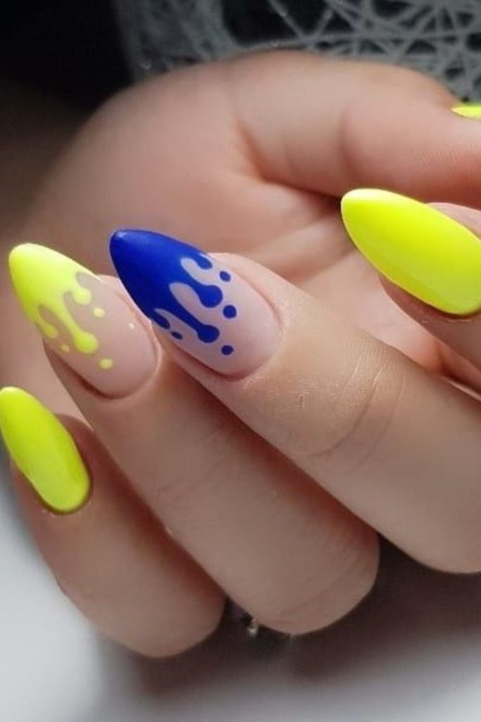 Sapphire blue nails with yellow drip effect.