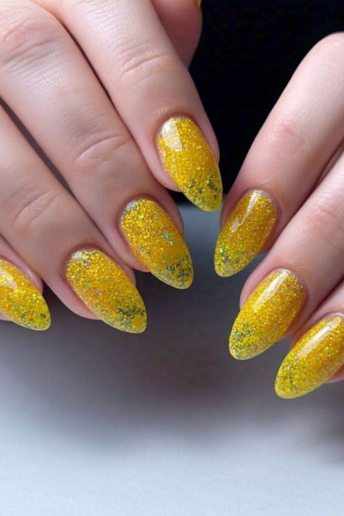 Lemon base nails with confetti sparkle festive playful citrus party style look.