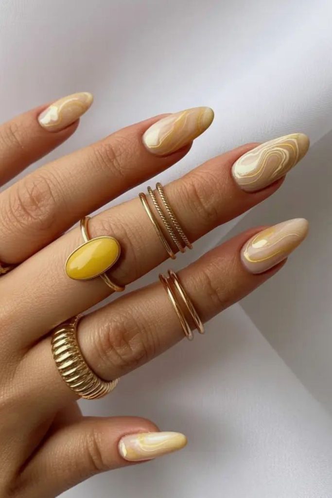 Chrome lemon swirl nails with metallic shine futuristic citrus inspired design effect.