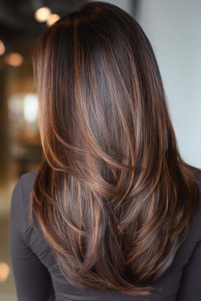 Maple brunette feathered highlighted hairstyle.