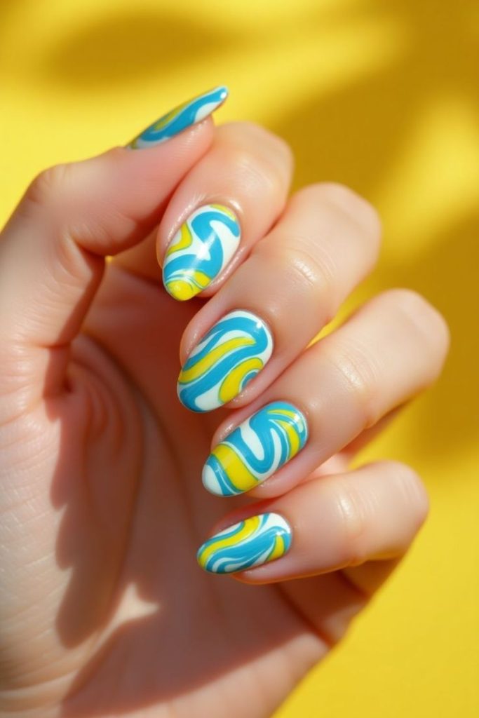 Blue wave nails with yellow sun reflections.