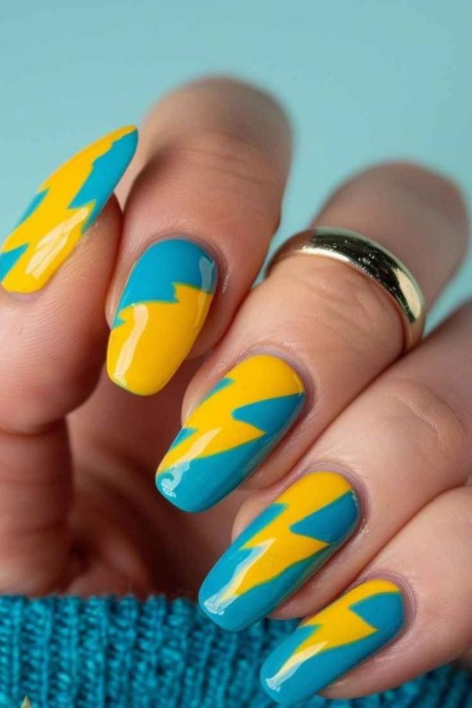 Blue grid nails with yellow geometric lines.