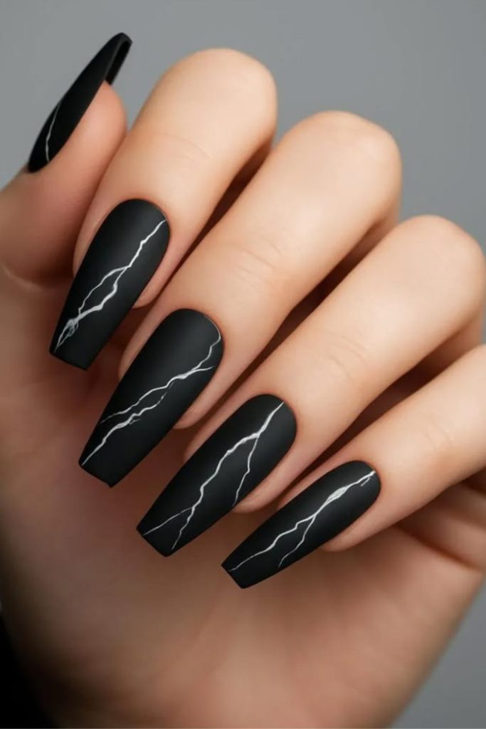 Matte black edgy glam nails.