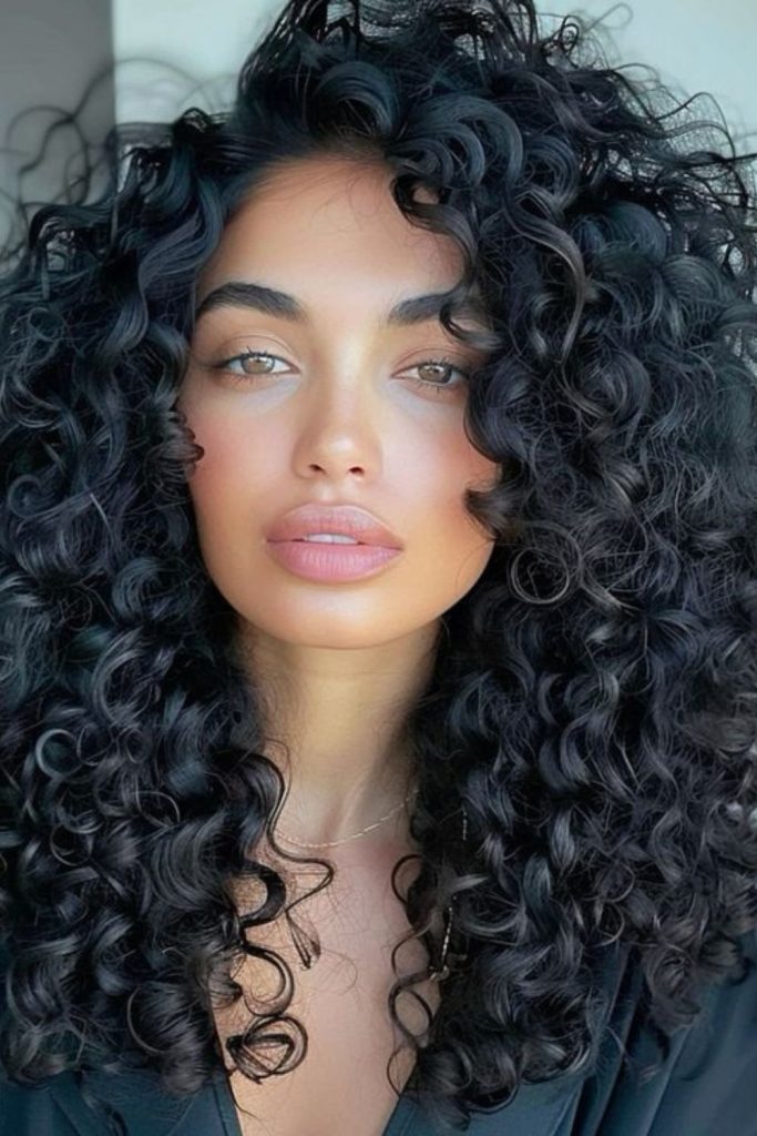 Dark elegant curly hairstyle with deep rhythmic flow.