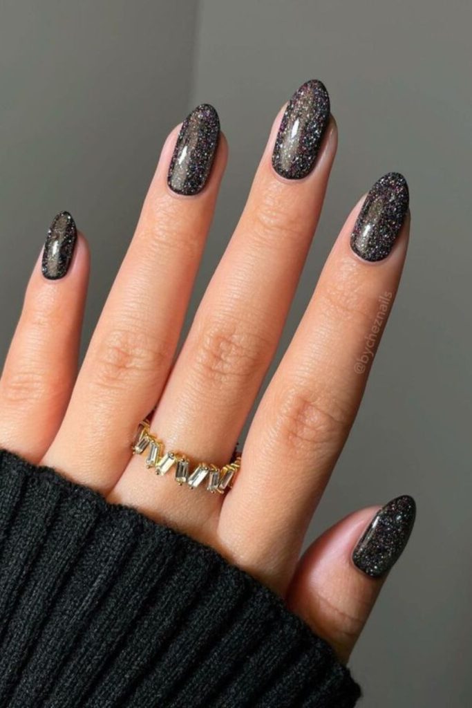 Black graduation nails with silver sparkle.