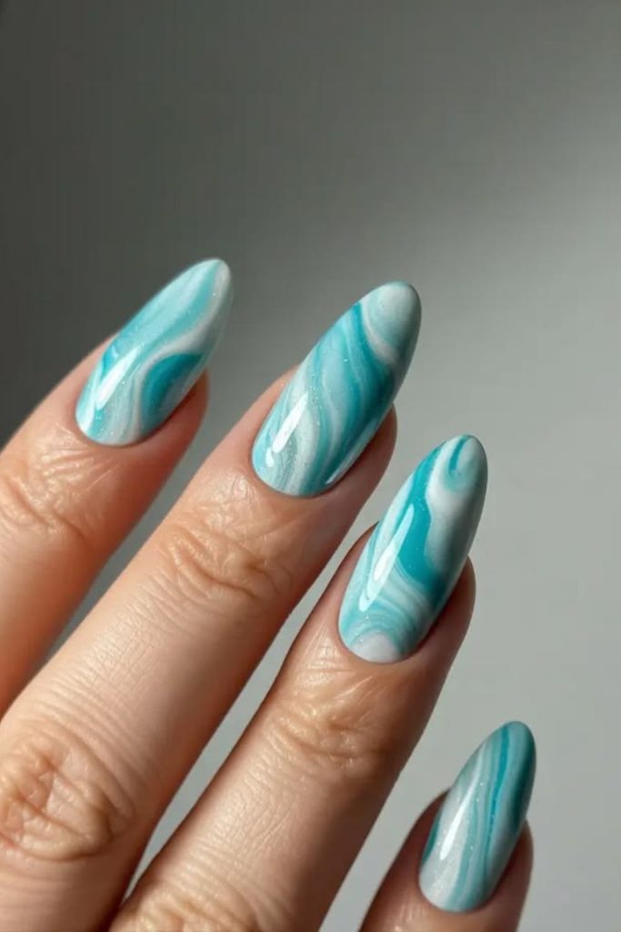 Blue ocean glass swirl nail design