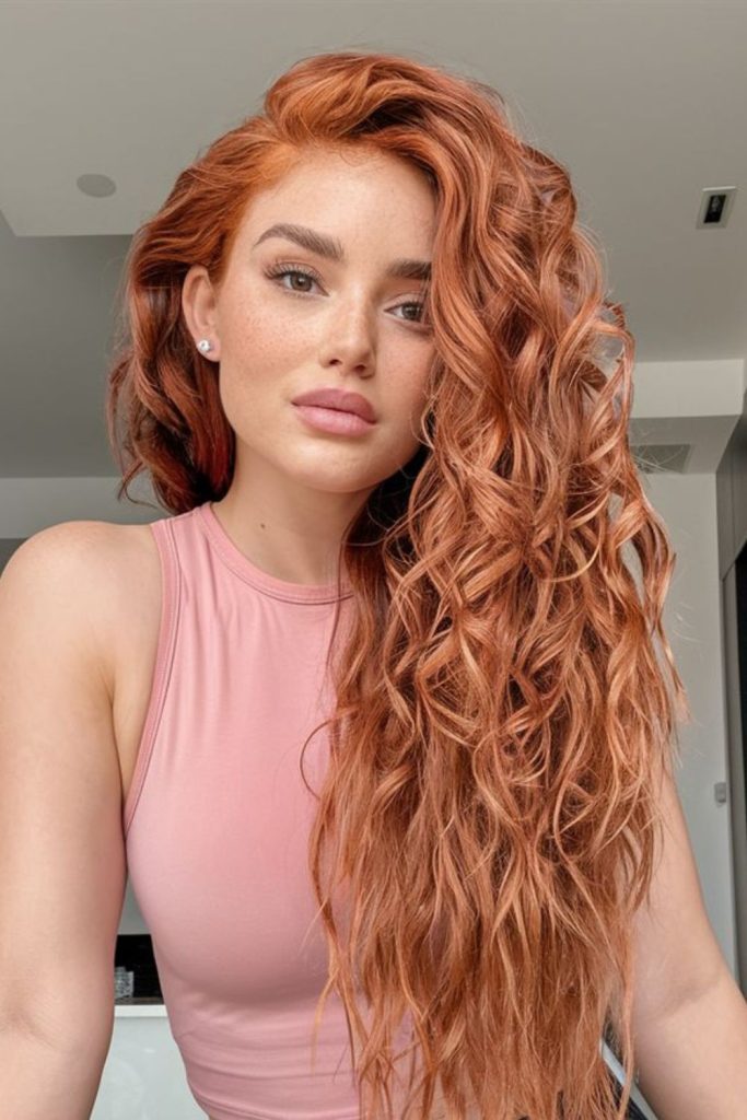 Peach toned blooming curls cascading with soft bounce