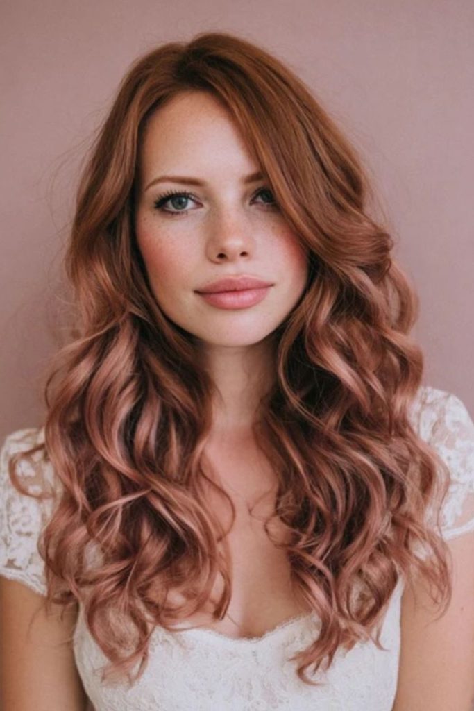 Rose tinted misty curls cascading softly around shoulders