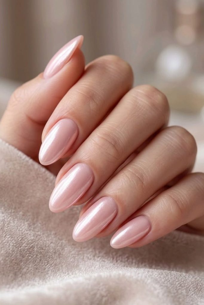 Blush pink graduation nails with pearls.