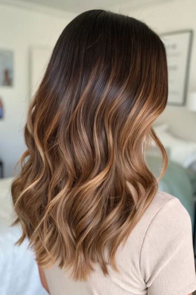 Brown blonde layered wavy hairstyle.