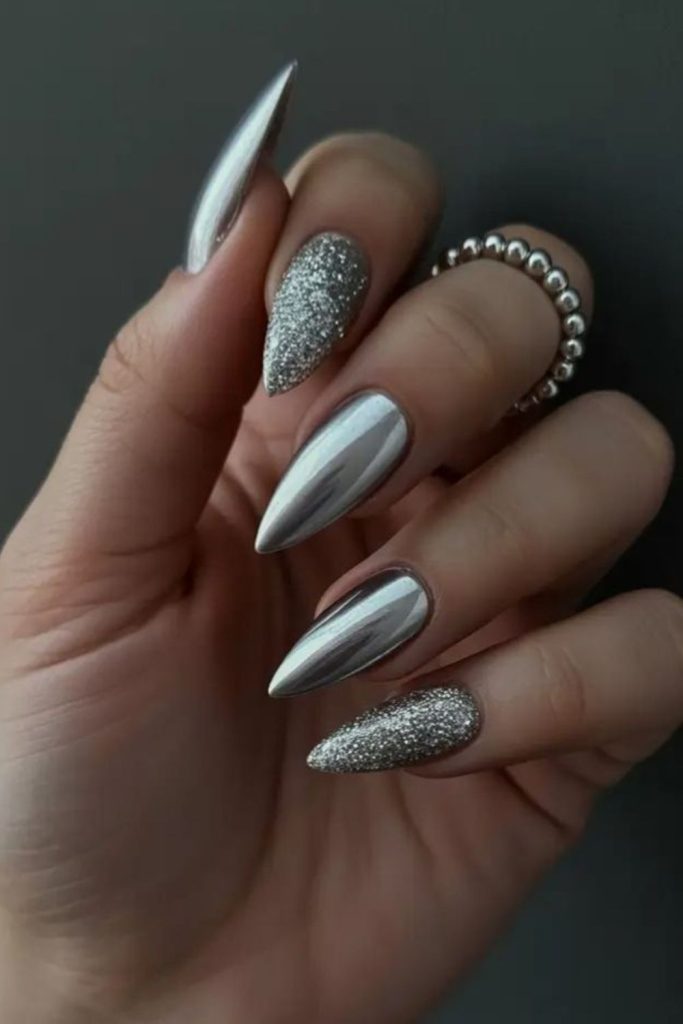 Metallic silver futuristic baddie nails.