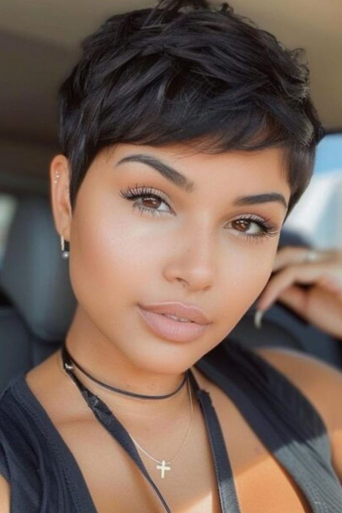 Ash toned pixie haircut with feathered layers and smooth fade transition effect.
