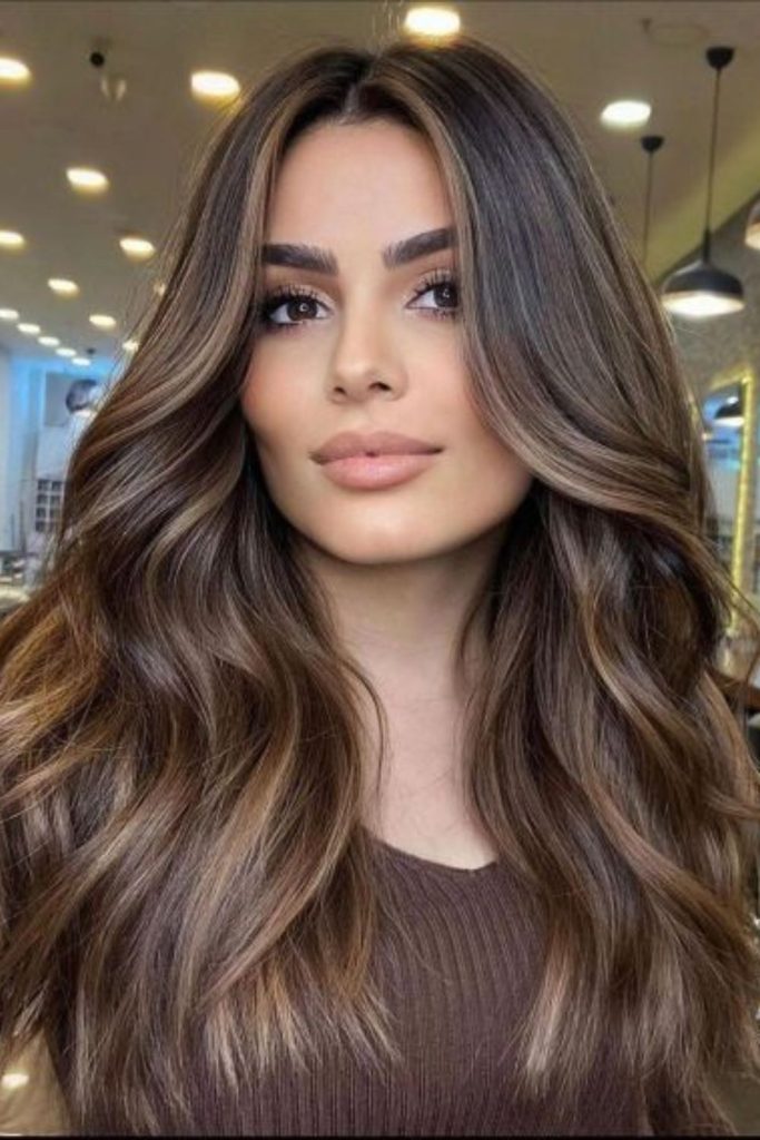 Smoky honey brunette curly hairstyle.