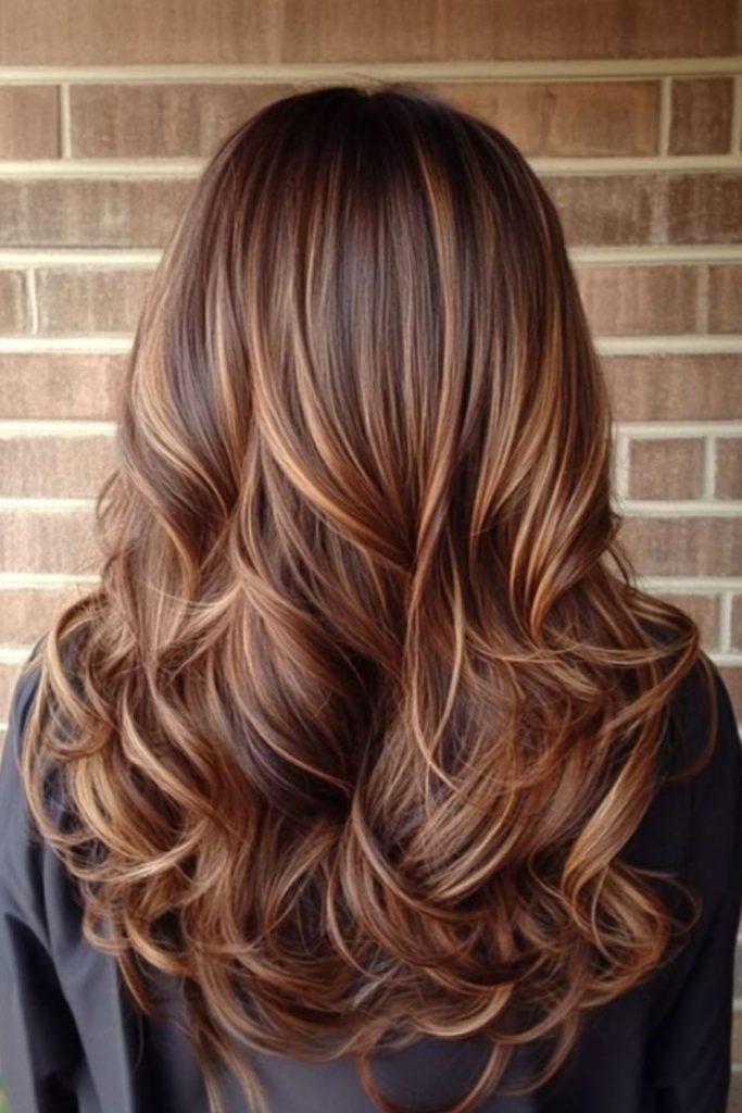 Sunlit blonde streaks on cocoa hair.