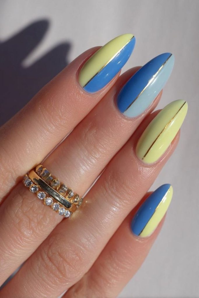 Denim blue nails with yellow edge detailing.