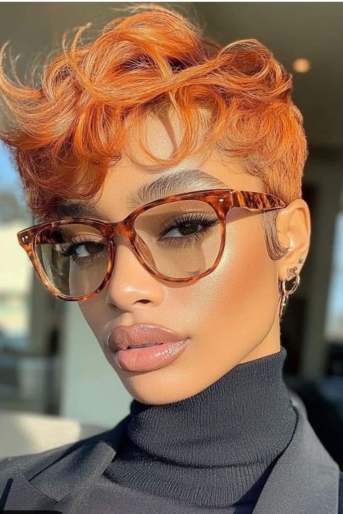 Bright orange pixie cut with energetic texture and bold vibrant style.