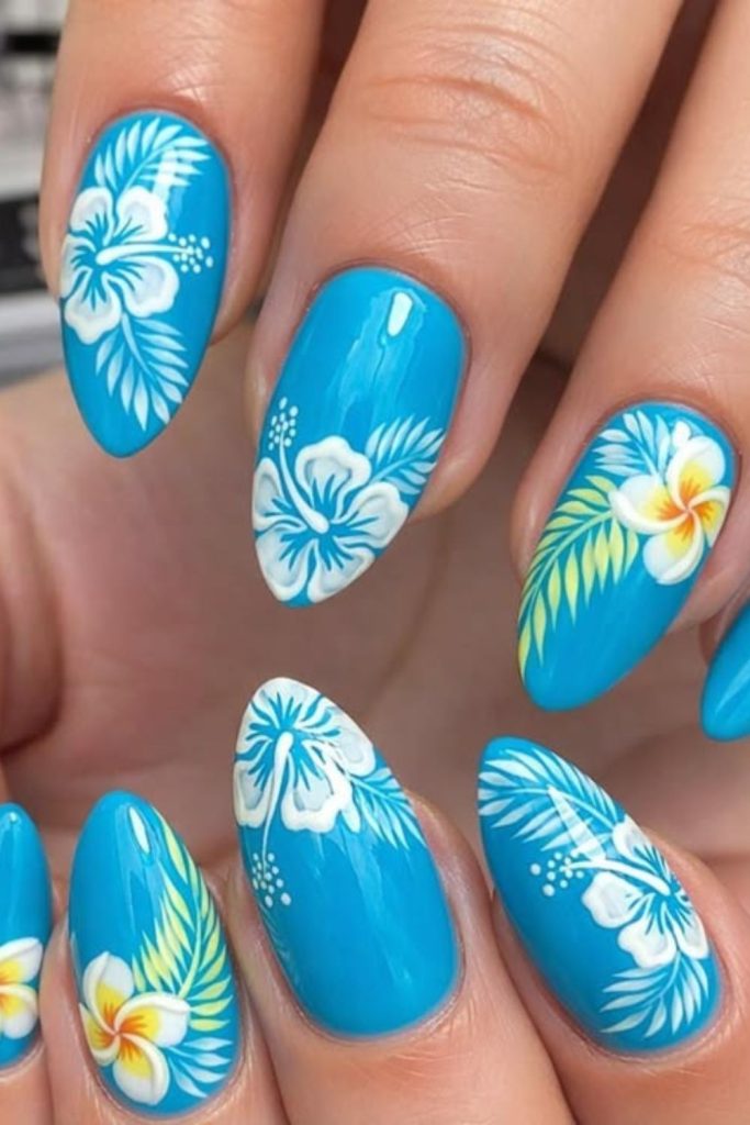 Blue nails with yellow tropical burst design.