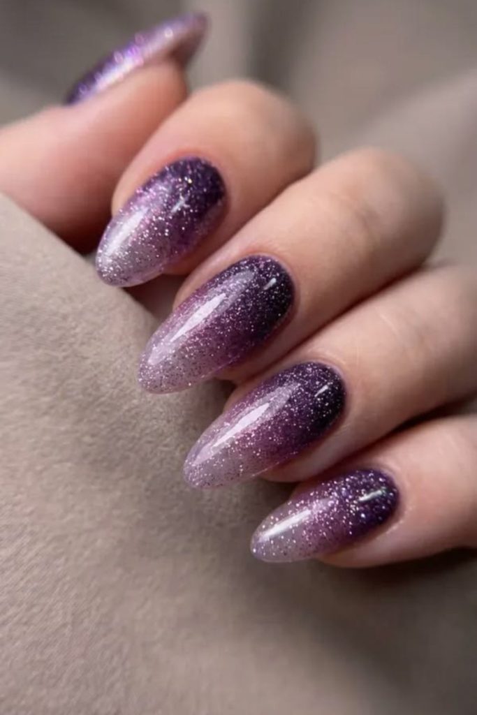 Smoky purple glitter graduation nails.