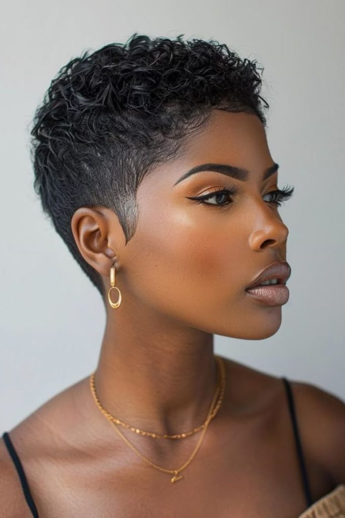 Ultra short pixie buzz cut with clean edges and minimal modern style.