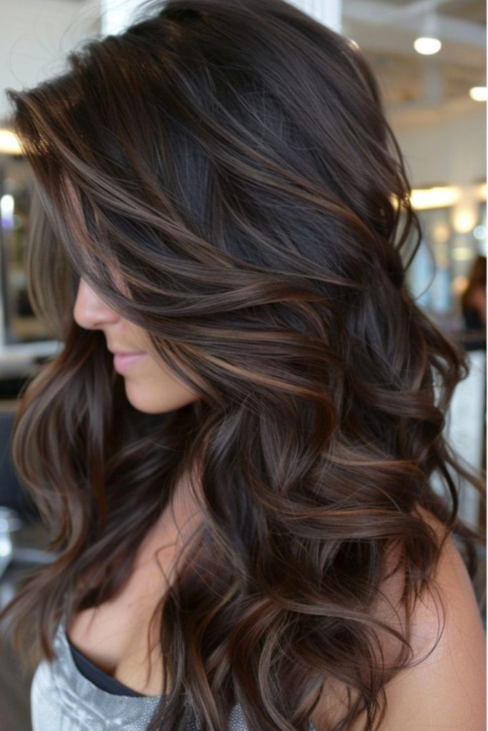 Espresso brunette curls with highlights.