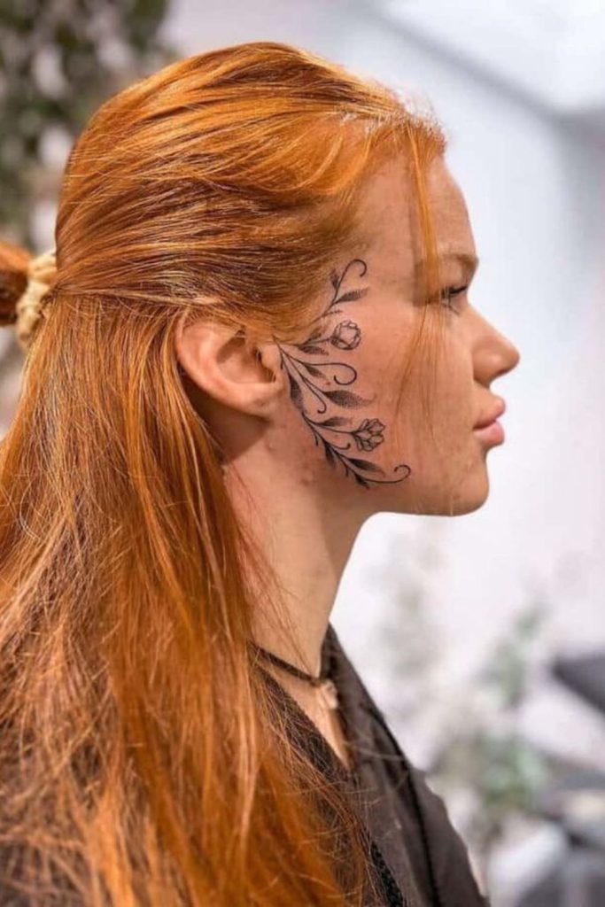 Baroque vine hairline tattoo royal styling.