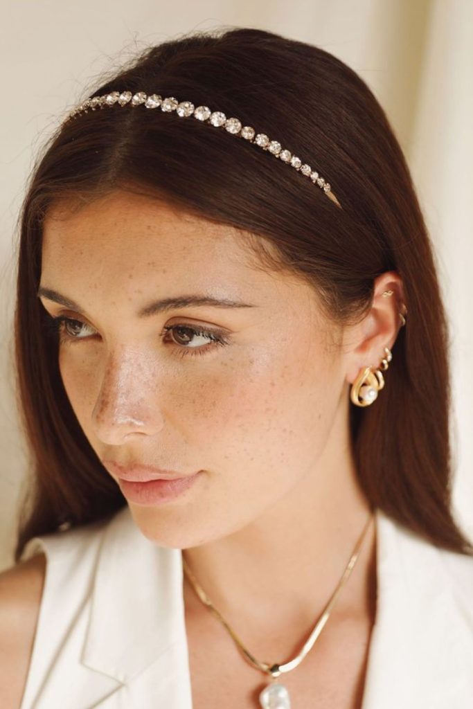 Crystal headband with layered flowing hairstyle.
