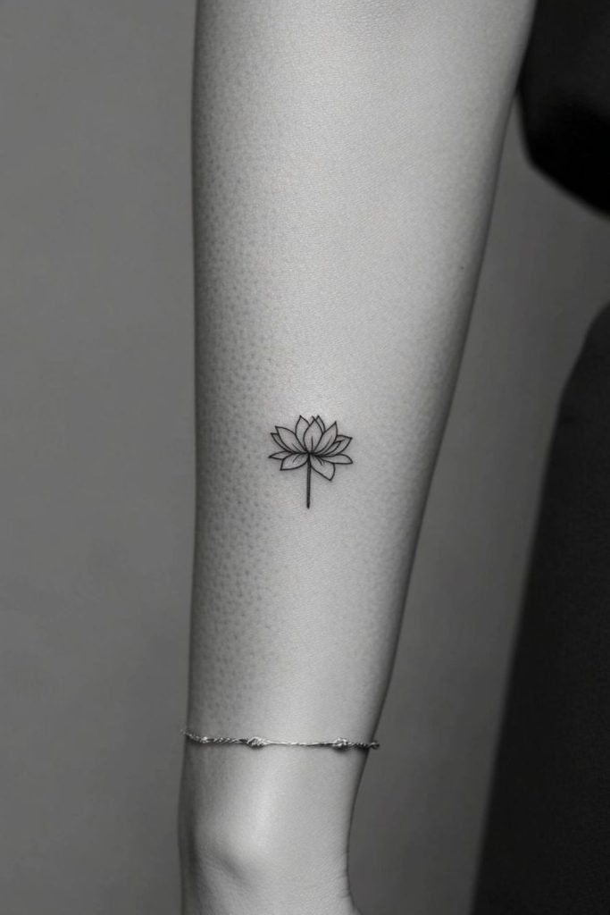 Tiny lotus flower elegant tattoo.