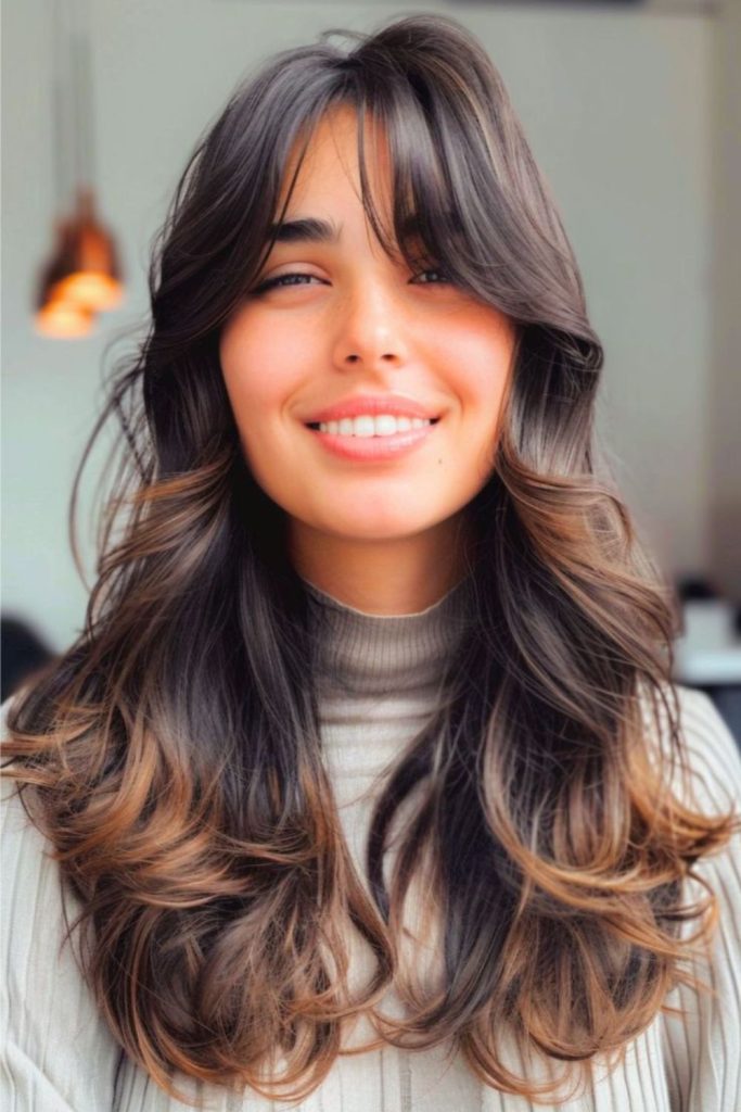 Ebony layered hairstyle with feathered bangs.