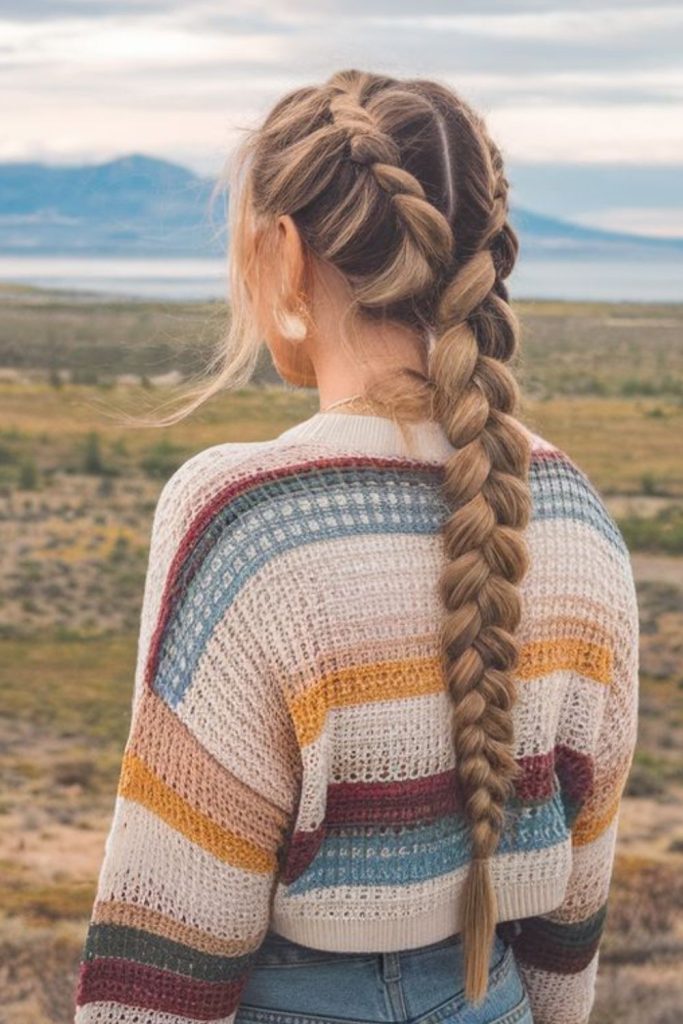 Evergreen fishtail braid outdoor hairstyle.