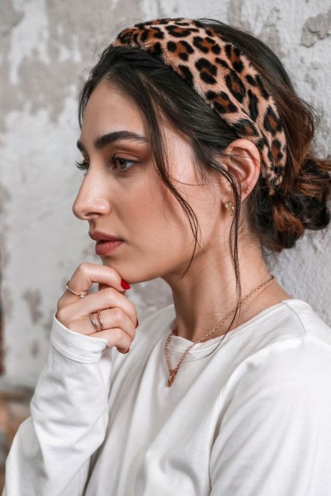 Feathered layered hairstyle with headband.