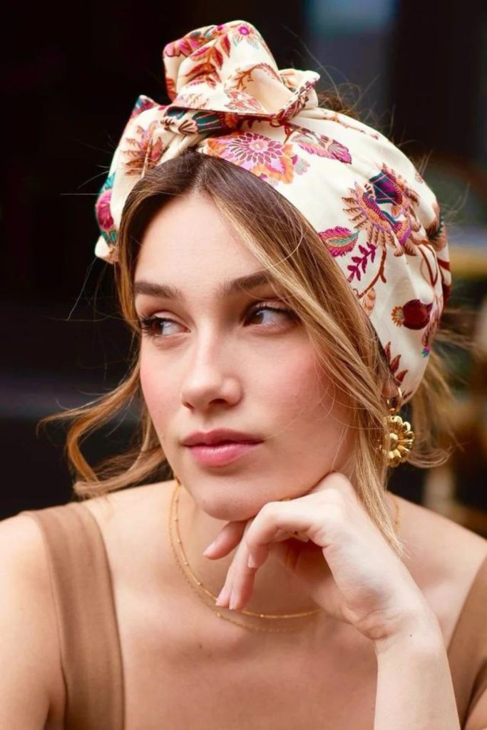 Floral headband with stylish ponytail look.