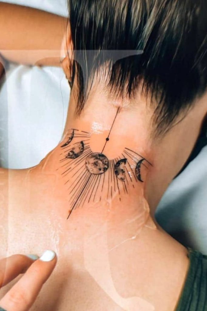 Crescent moon hairline tattoo glowing softly.