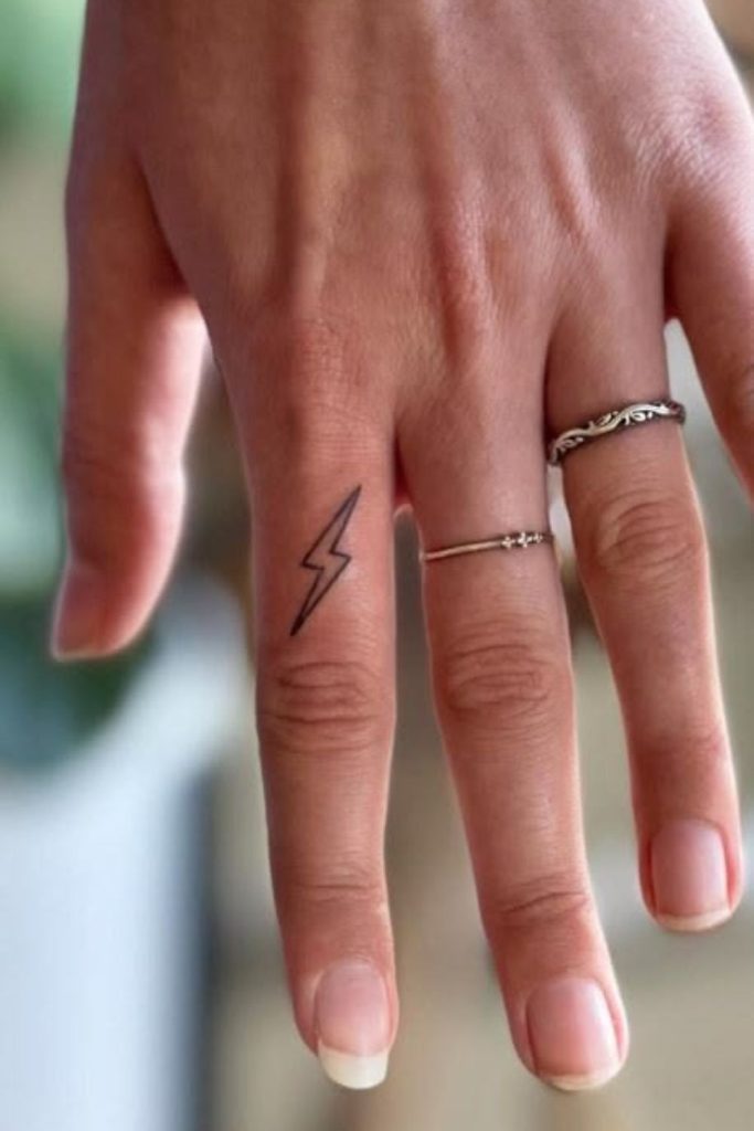 Small lightning bolt modern tattoo style.