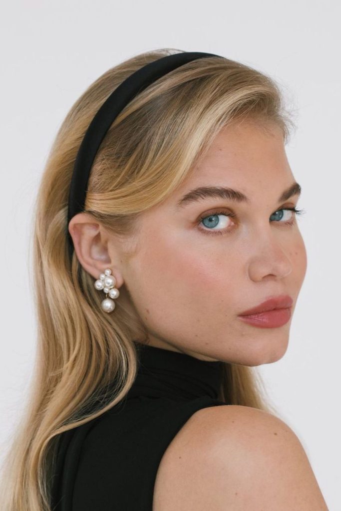 Black satin headband on sleek strands.