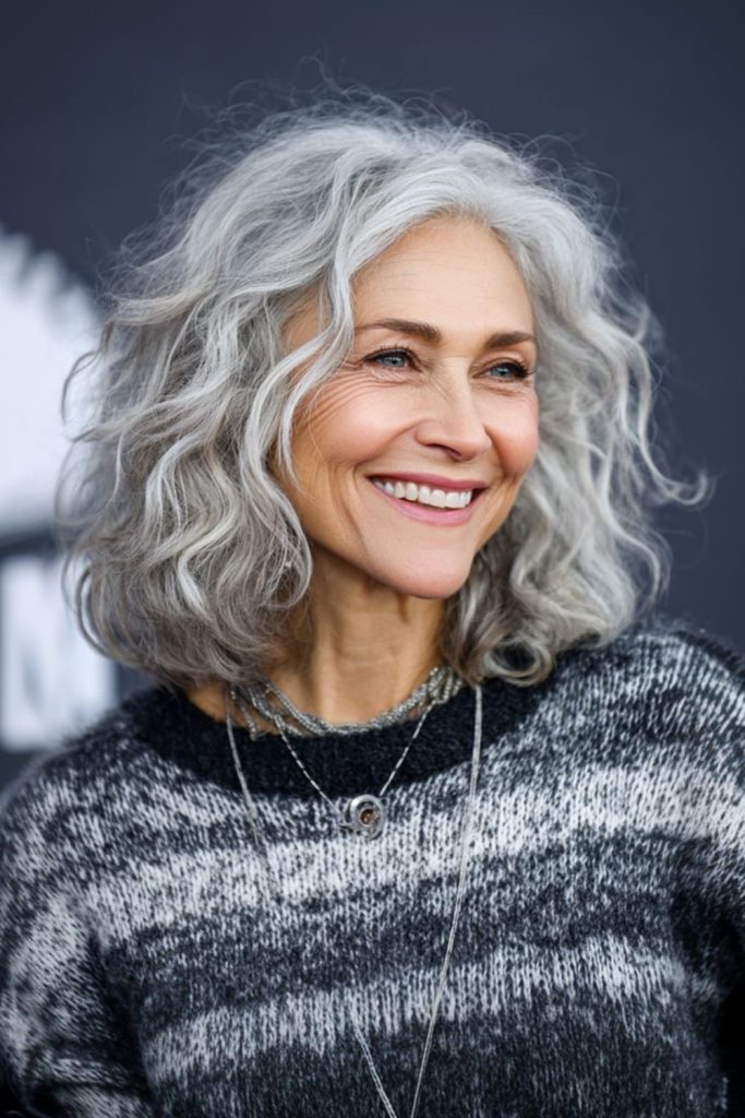 Shoulder length moonstone gray curls.