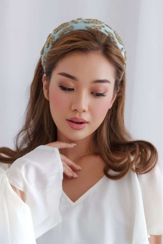 Jeweled headband with dramatic side sweep.
