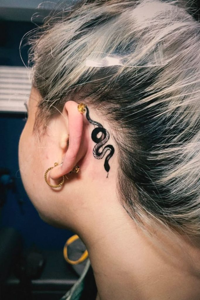 Serpent hairline tattoo jewel inspired style.