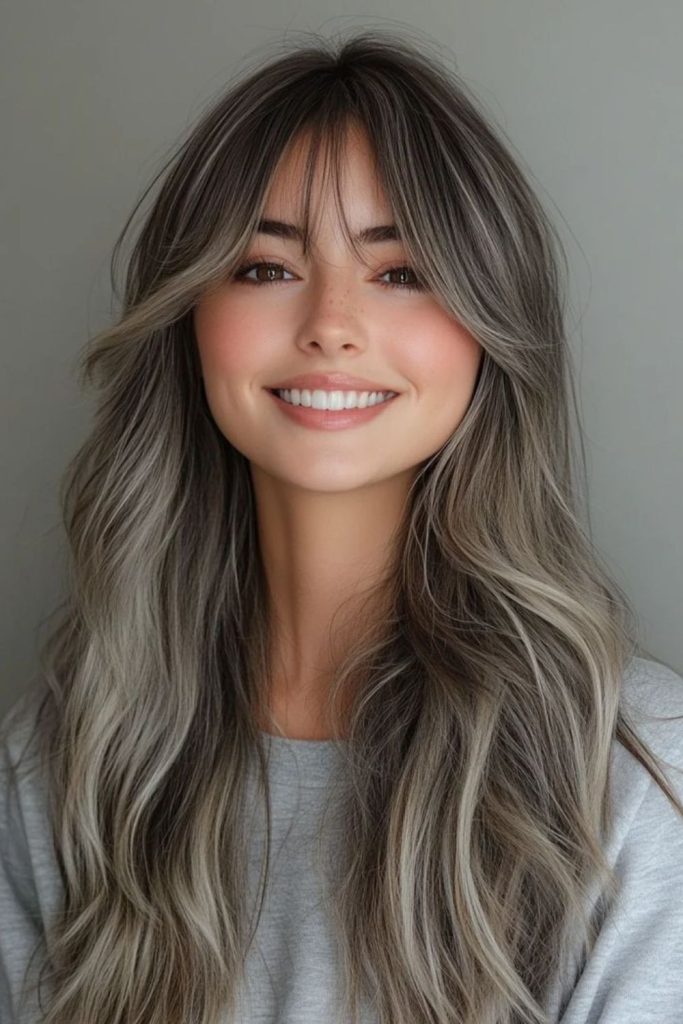 Silver layered hairstyle with wispy bangs.