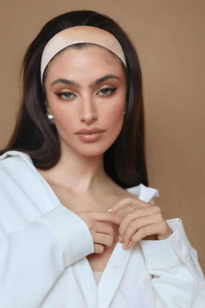 Sleek straight hair with satin headband.