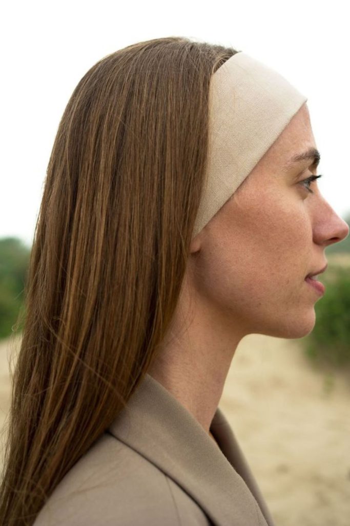 Linen headband with casual shoulder-length hair.