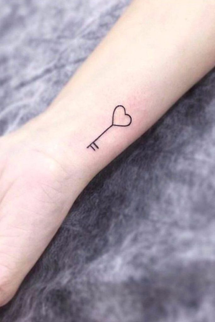 Small key tattoo with vintage charm.
