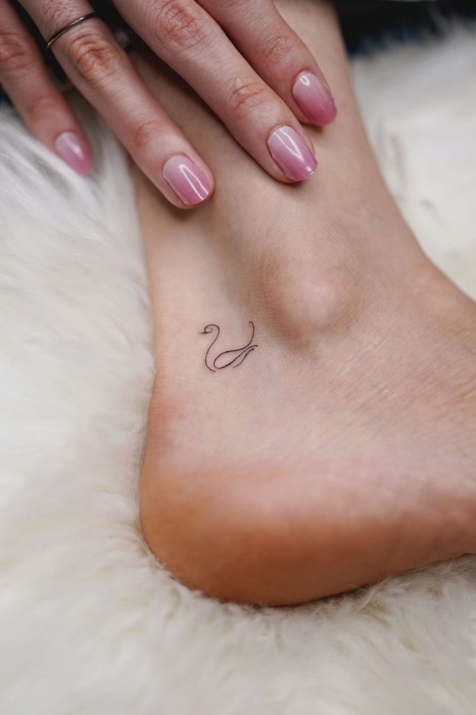 Small swan silhouette graceful tattoo design.