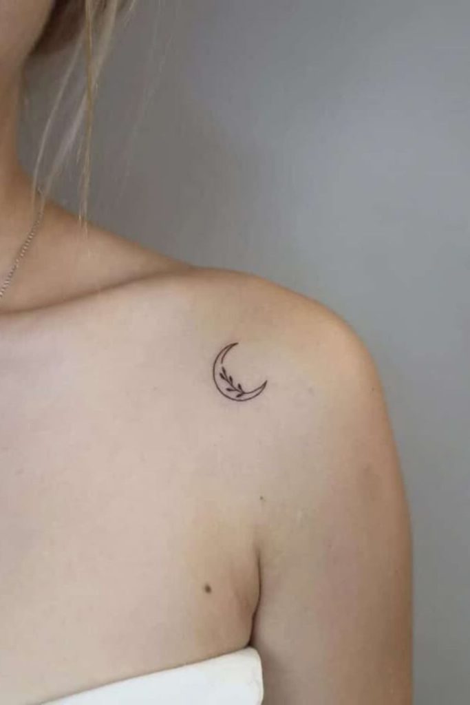 Tiny crescent moon tattoo design.