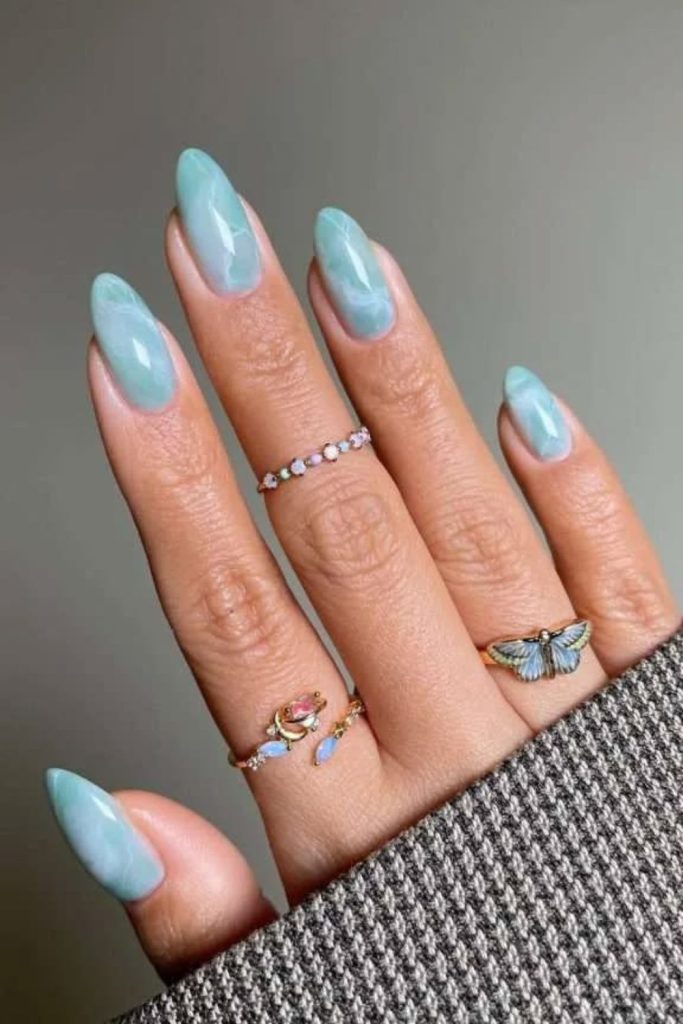 Aquamarine ocean nails with wave details.