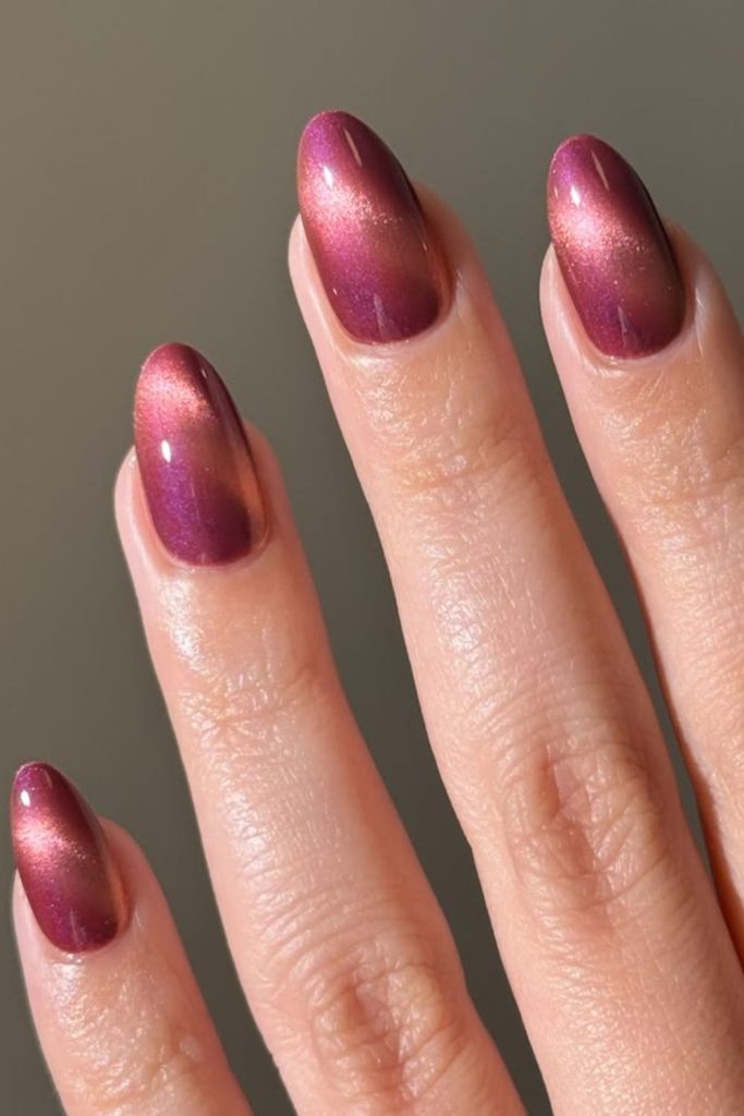 Berry shimmer sunset inspired nail design.