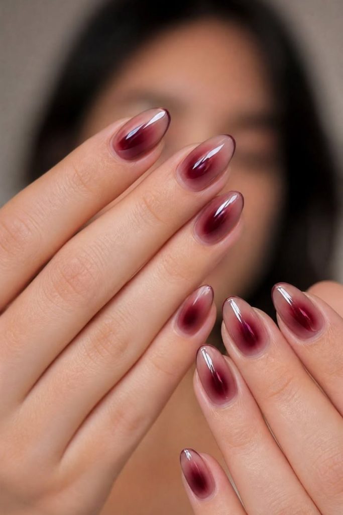 Burgundy aura nails with smoky gradient.