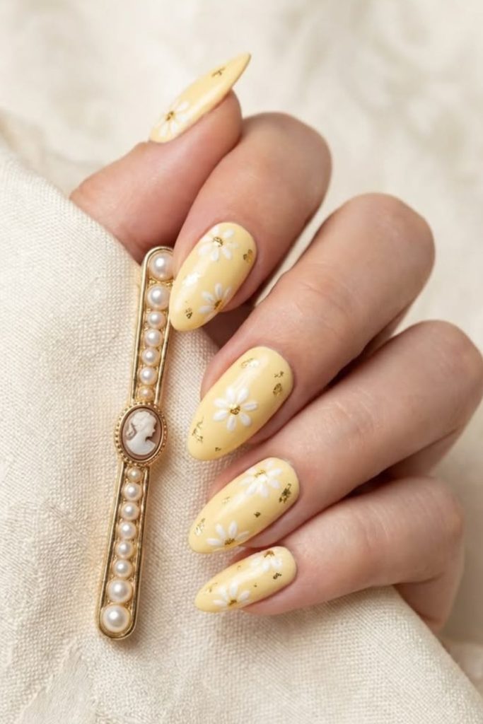 Butter yellow nails with tiny daisies.
