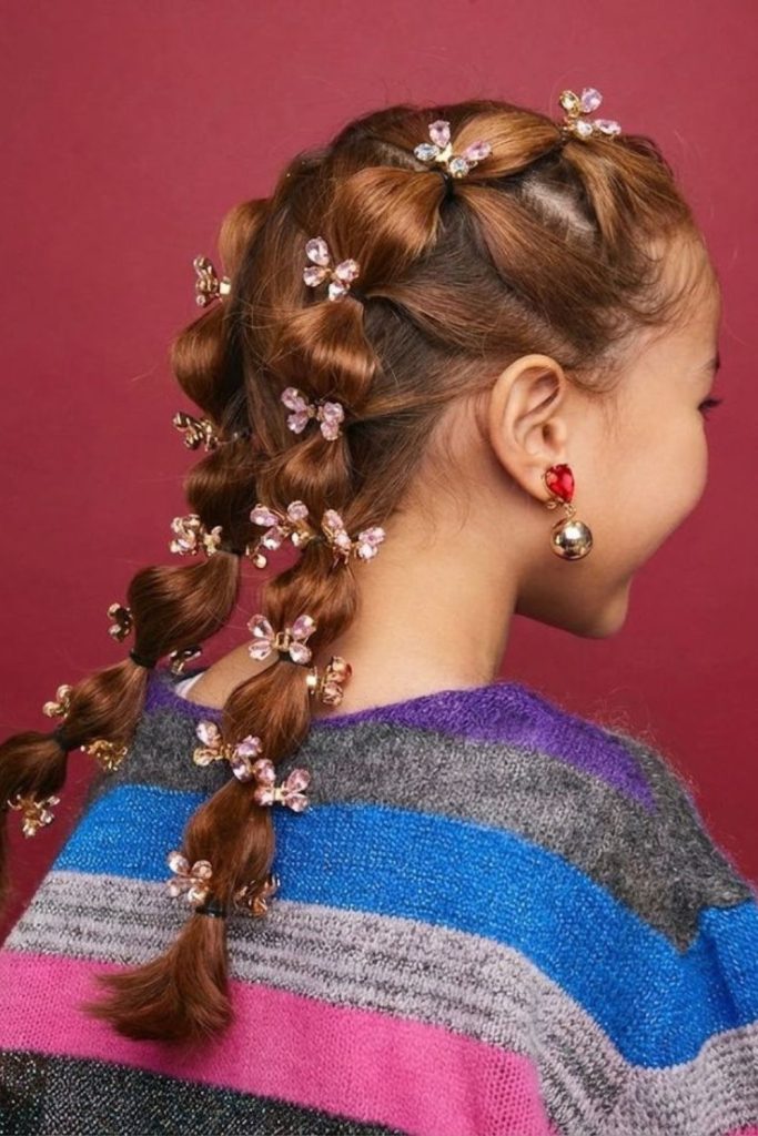 Butterfly clips decorating braided hairstyle.