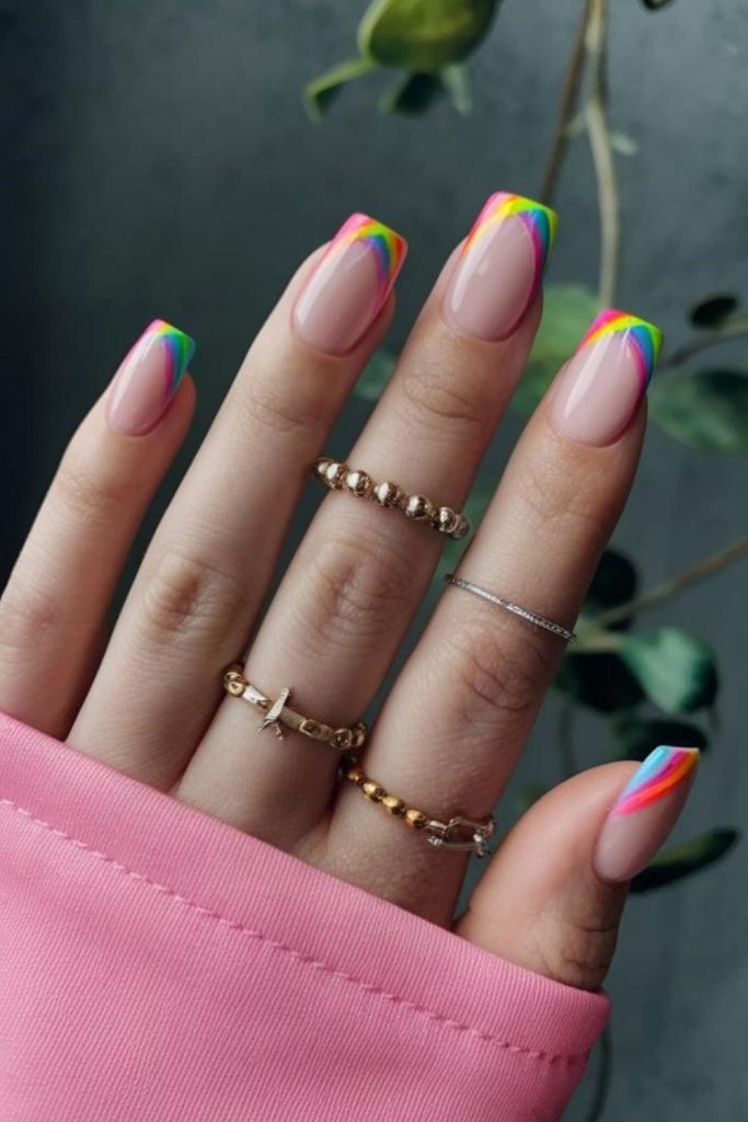 Rainbow French tip teacher manicure.